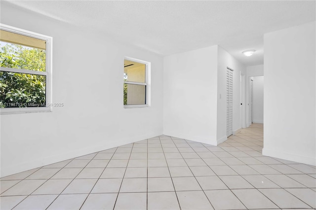 3524 NW 4th Ter, Miami, FL 33125 - unfurnished room with plenty of natural light, a textured ceiling, and light tile patterned flooring