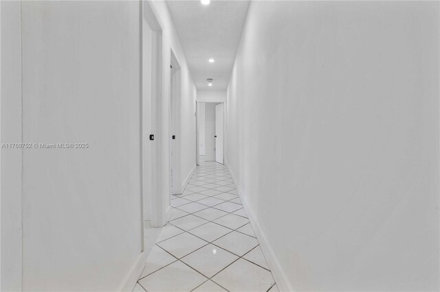 3524 NW 4th Ter, Miami, FL 33125 - hall featuring light tile patterned flooring and baseboards
