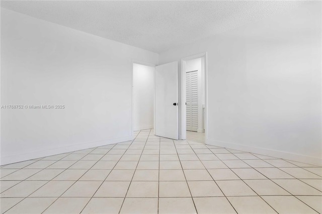 3524 NW 4th Ter, Miami, FL 33125 - unfurnished room featuring baseboards and a textured ceiling