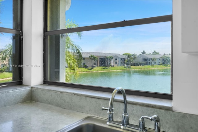 interior details featuring a water view and a sink