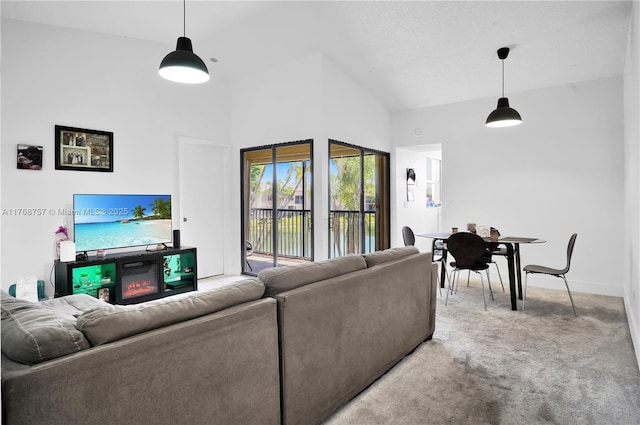 living area featuring high vaulted ceiling, carpet flooring, and baseboards