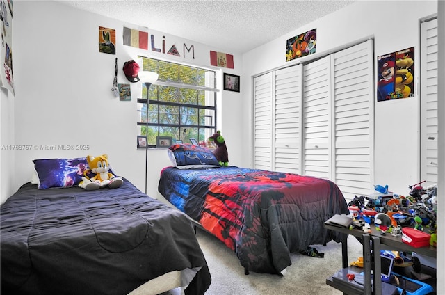 bedroom with a textured ceiling, a closet, and carpet