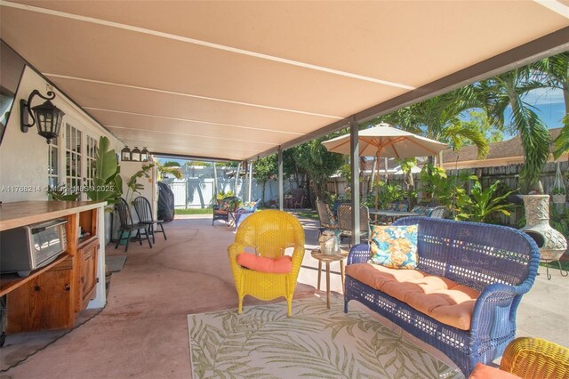 5950 NW 192nd St, Hialeah, FL 33015 - fenced backyard featuring a patio, outdoor dining area, and an outdoor hangout area