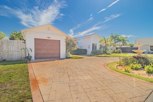 5950 NW 192nd St, Hialeah, FL 33015 - garage featuring decorative driveway