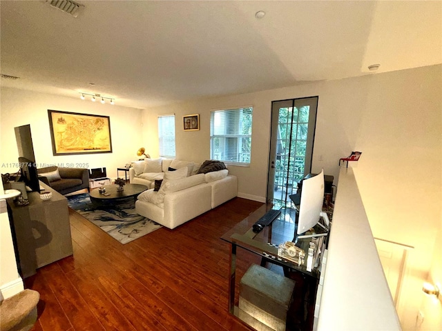 living room featuring visible vents, rail lighting, and wood finished floors