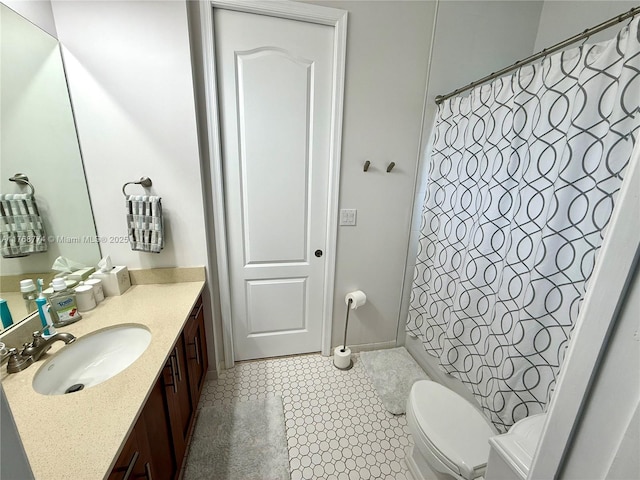 bathroom featuring tile patterned flooring, toilet, vanity, and a shower with curtain