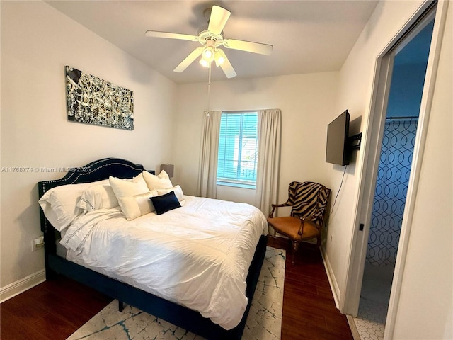 bedroom featuring ceiling fan, baseboards, and wood finished floors