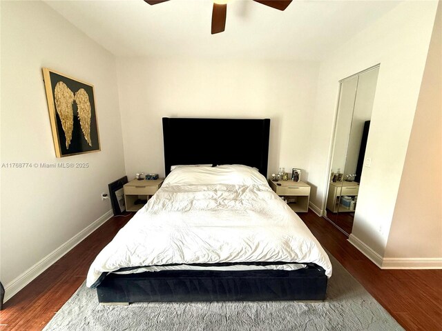 bedroom featuring a ceiling fan, baseboards, and wood finished floors