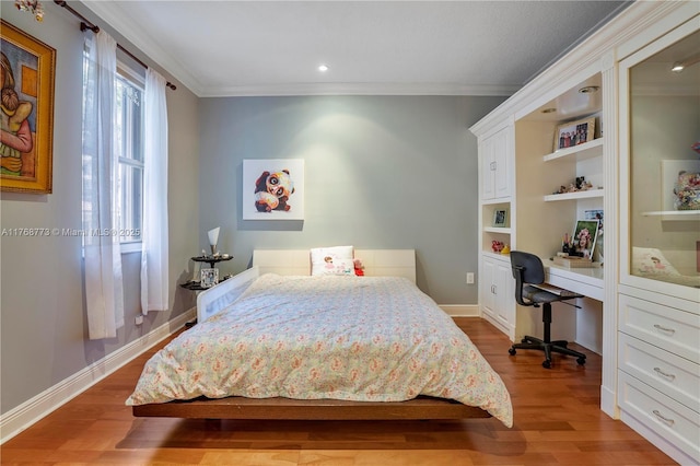 21109 NE 38th Ave Unit 74, Aventura, FL 33180 - bedroom featuring built in desk, ornamental molding, and wood finished floors