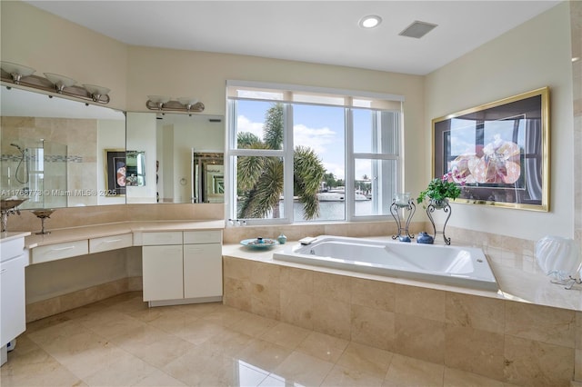 21109 NE 38th Ave Unit 74, Aventura, FL 33180 - bathroom with visible vents, a shower stall, a garden tub, tile patterned floors, and vanity