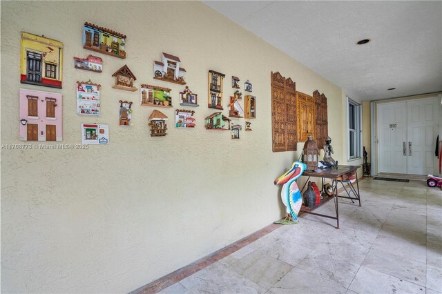 21109 NE 38th Ave Unit 74, Aventura, FL 33180 - hall with a textured wall and a textured ceiling
