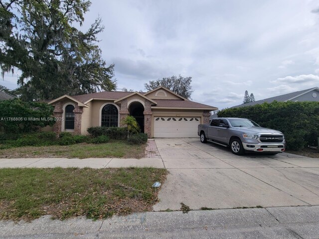 4904 Yellowstone Dr, New Port Richey, FL 34655 - single story home featuring a garage, concrete driveway, and stucco siding