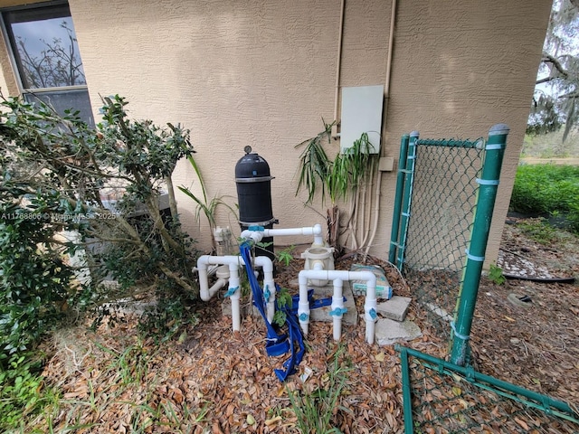 4904 Yellowstone Dr, New Port Richey, FL 34655 - exterior view of stucco siding and pump