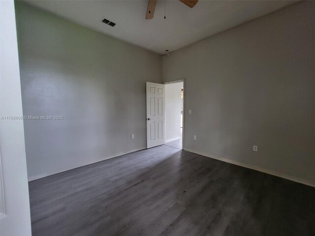 4904 Yellowstone Dr, New Port Richey, FL 34655 - unfurnished room with a ceiling fan, dark wood finished floors, and baseboards