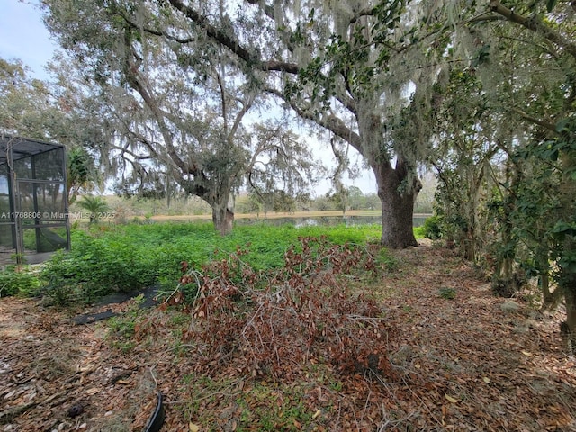 4904 Yellowstone Dr, New Port Richey, FL 34655 - view of yard with a water view and glass enclosure