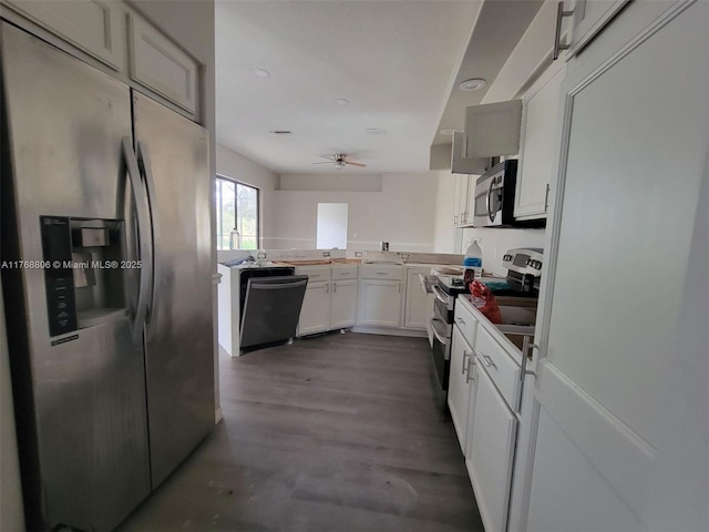 4904 Yellowstone Dr, New Port Richey, FL 34655 - kitchen with appliances with stainless steel finishes, ceiling fan, a peninsula, white cabinetry, and dark wood finished floors