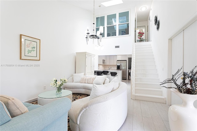 4016 Palm Bay Cir Unit C, West Palm Beach, FL 33406 - living area with a towering ceiling, a chandelier, and stairs