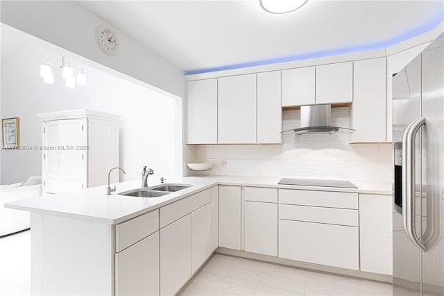 4016 Palm Bay Cir Unit C, West Palm Beach, FL 33406 - kitchen with wall chimney range hood, stainless steel fridge with ice dispenser, a sink, black electric cooktop, and a peninsula