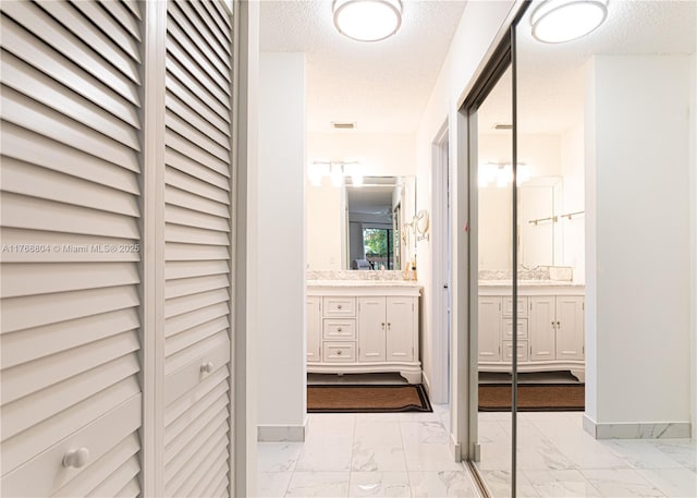 4016 Palm Bay Cir Unit C, West Palm Beach, FL 33406 - hall with light marble finish flooring, a textured ceiling, and baseboards