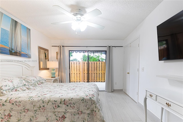4016 Palm Bay Cir Unit C, West Palm Beach, FL 33406 - bedroom featuring access to exterior, a textured ceiling, and ceiling fan