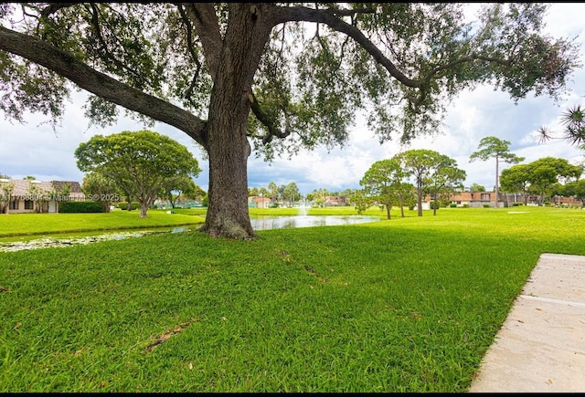 4016 Palm Bay Cir Unit C, West Palm Beach, FL 33406 - view of community with a water view and a yard
