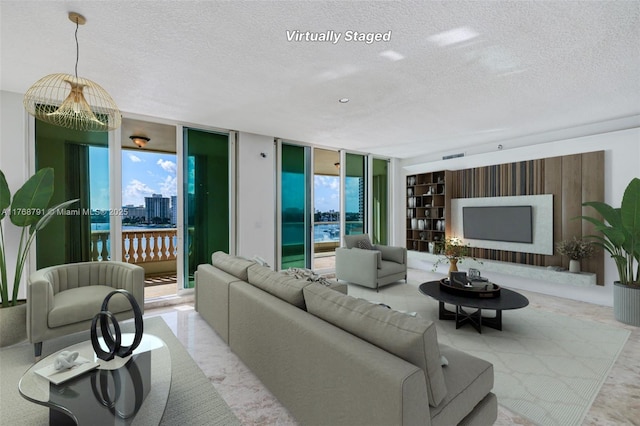 550 SE 5th Ave Unit 606S, Boca Raton, FL 33432 - living room featuring a textured ceiling, healthy amount of natural light, and built in shelves