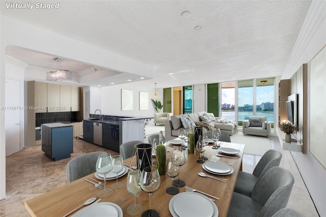 550 SE 5th Ave Unit 606S, Boca Raton, FL 33432 - dining space featuring a textured ceiling and ornamental molding