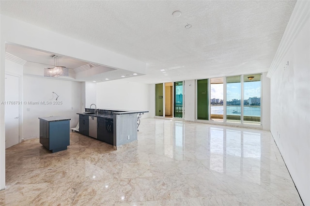 550 SE 5th Ave Unit 606S, Boca Raton, FL 33432 - kitchen with a kitchen island with sink, stainless steel dishwasher, a wall of windows, open floor plan, and a textured ceiling