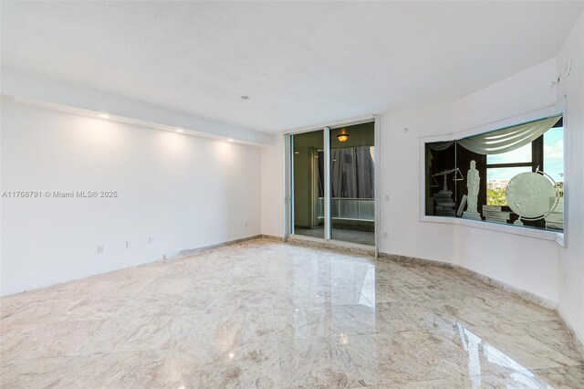 550 SE 5th Ave Unit 606S, Boca Raton, FL 33432 - empty room featuring baseboards and marble tiled floors