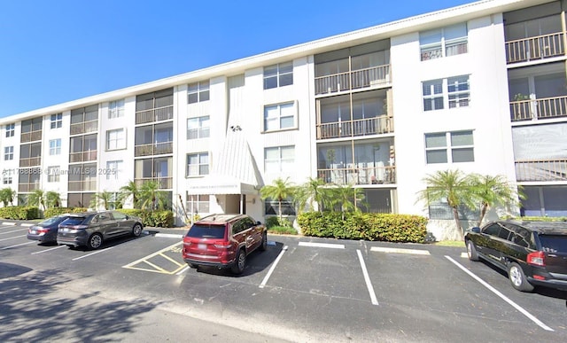 view of building exterior featuring uncovered parking