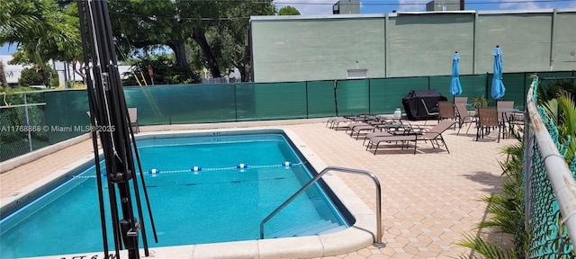 community pool featuring a patio area and fence