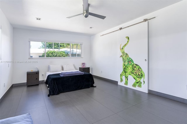 501 NE 51st St, Miami, FL 33137 - tiled bedroom with baseboards and a ceiling fan