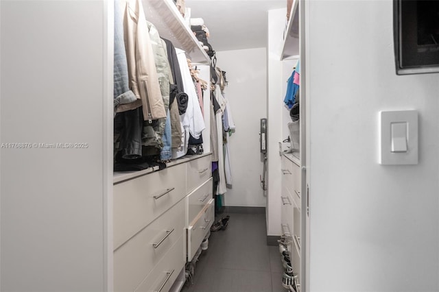 spacious closet with tile patterned floors