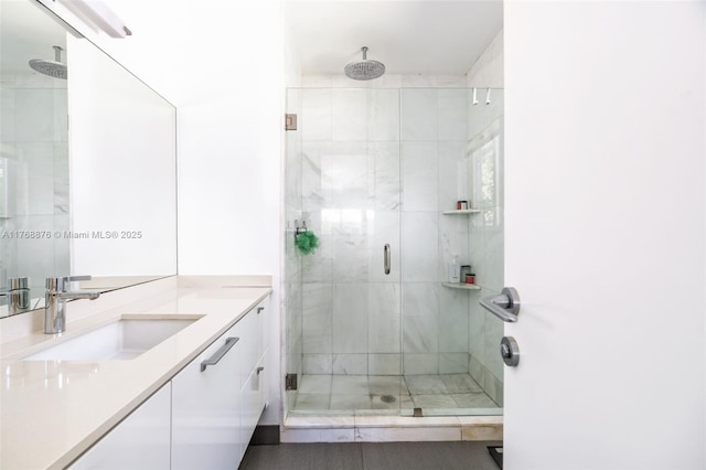 full bath with a stall shower and vanity