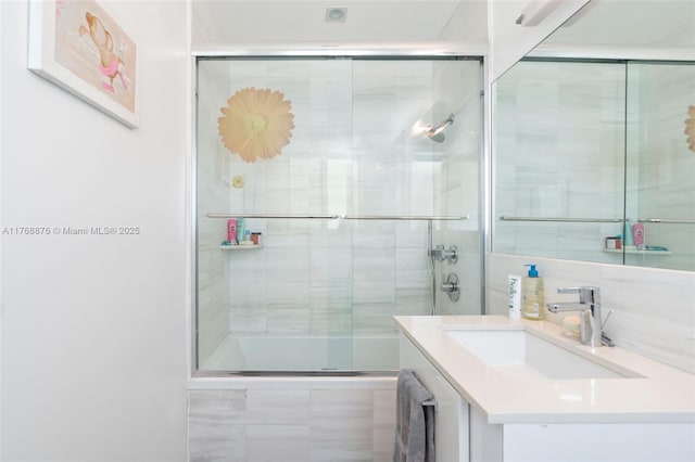 bathroom featuring vanity and tiled shower