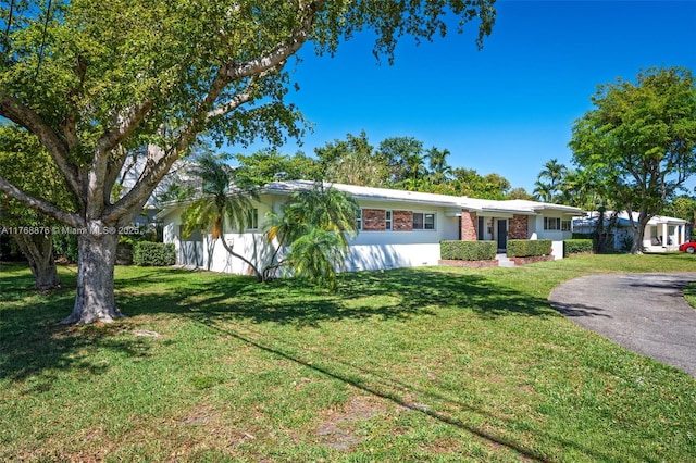 501 NE 51st St, Miami, FL 33137 - ranch-style house featuring a front yard and driveway