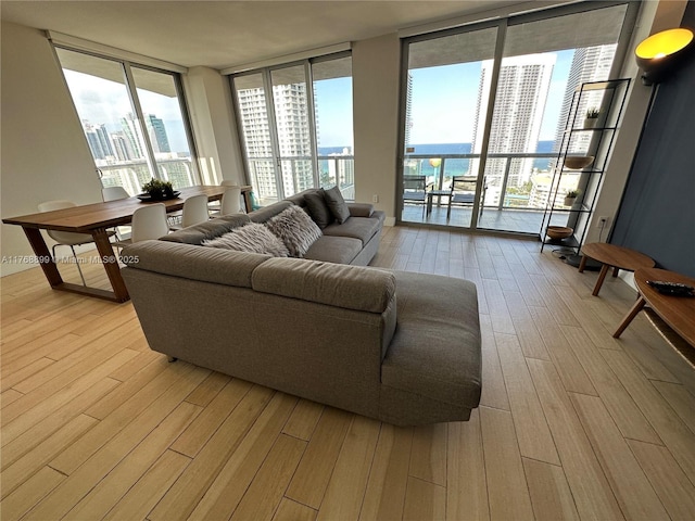2600 E Hallandale Beach Blvd Unit T2202, Hallandale Beach, FL 33009 - living room featuring a view of city, a wall of windows, a healthy amount of sunlight, and light wood-style floors
