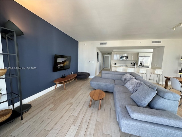 2600 E Hallandale Beach Blvd Unit T2202, Hallandale Beach, FL 33009 - living room with visible vents, baseboards, and light wood-type flooring