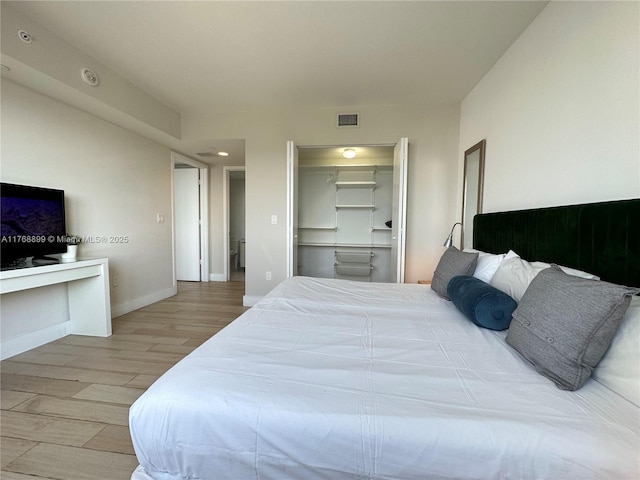 2600 E Hallandale Beach Blvd Unit T2202, Hallandale Beach, FL 33009 - bedroom featuring a walk in closet, recessed lighting, baseboards, wood finished floors, and visible vents