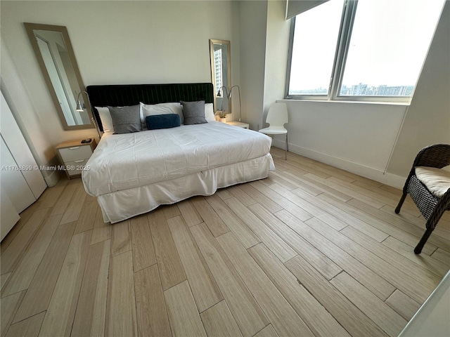 2600 E Hallandale Beach Blvd Unit T2202, Hallandale Beach, FL 33009 - bedroom with baseboards and light wood-style flooring