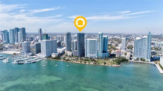 birds eye view of property with a water view and a city view