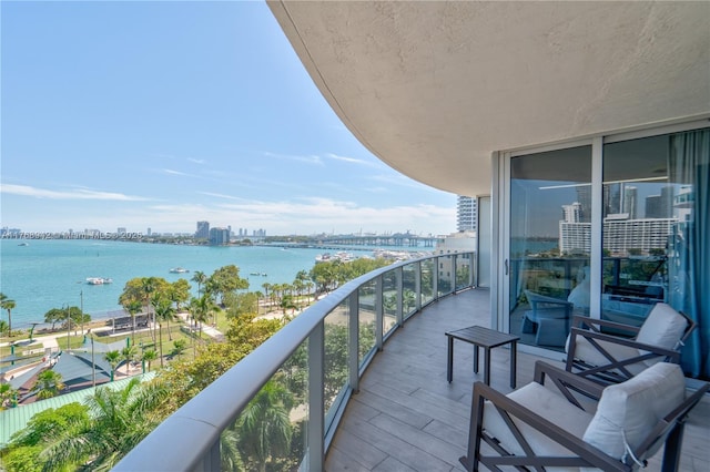 balcony with a view of city and a water view
