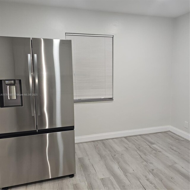442 SW 22nd Ave, Fort Lauderdale, FL 33312 - kitchen view of stainless steel refrigerator with ice dispenser, baseboards, and light wood finished floors