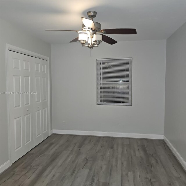 442 SW 22nd Ave, Fort Lauderdale, FL 33312 - unfurnished bedroom with wood finished floors, baseboards, a closet, and a ceiling fan