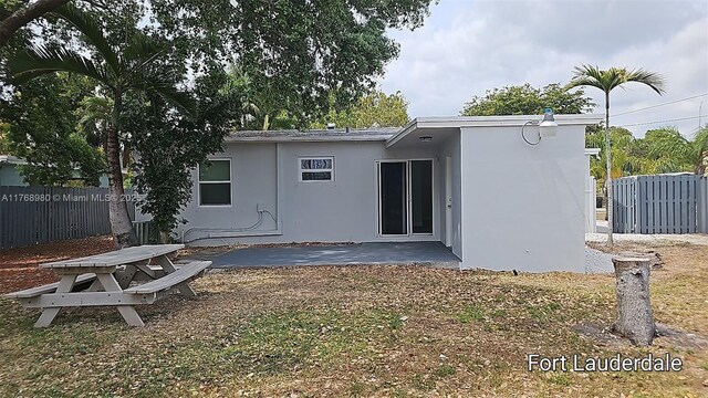 442 SW 22nd Ave, Fort Lauderdale, FL 33312 - back of property featuring stucco siding, a patio area, and fence