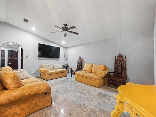 living area with lofted ceiling, visible vents, arched walkways, and ceiling fan