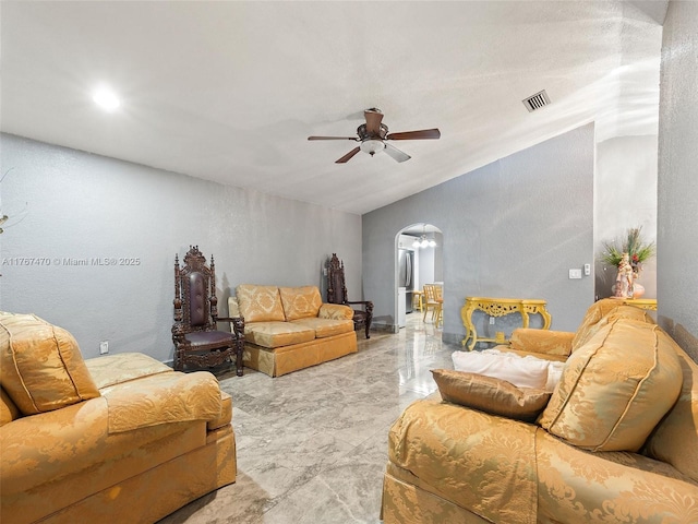 living room with vaulted ceiling, a ceiling fan, marble finish floor, arched walkways, and visible vents