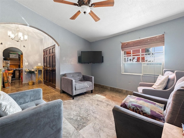 living area featuring arched walkways, lofted ceiling, a textured ceiling, and ceiling fan with notable chandelier