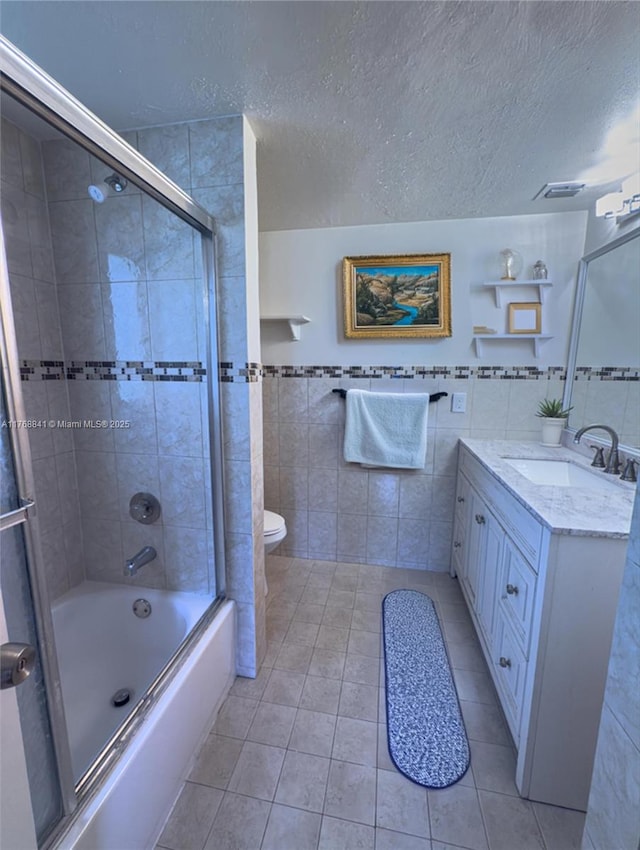 1103 NW 58th Ter Unit 224, Sunrise, FL 33313 - full bath with tile walls, tile patterned flooring, vanity, shower / bath combination with glass door, and a textured ceiling