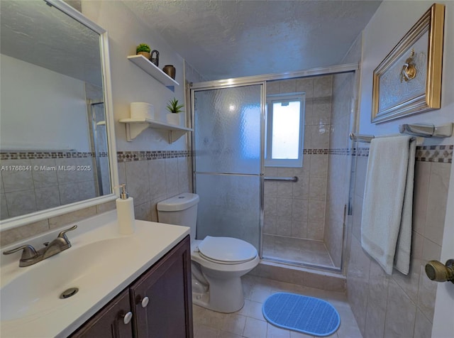 1103 NW 58th Ter Unit 224, Sunrise, FL 33313 - full bathroom featuring tile walls, tile patterned flooring, a shower stall, a textured ceiling, and vanity
